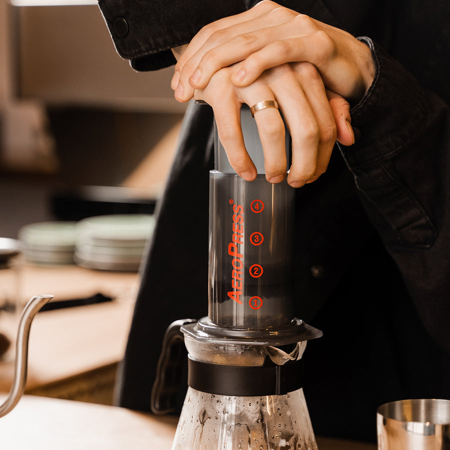 Lifestyle shot of Aeropress brewing Danger Coffee for fresh, mold-free clean energy