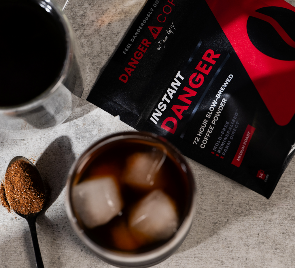 Instant Danger coffee package with a cup of iced coffee on a counter